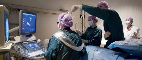Monique Haak (midden) en Frans Klumper (rechts) voeren een laserbehandeling uit vanwege een tweelingtransfusiesyndroom.